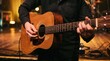 © Olivia - Musician playing acoustic guitar on stage with warm lighting, live concert performance, musical instrument closeup, artistic atmosphere, entertainment industry, rock or folk music