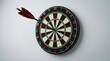 © Nuttawut - Precision Strike: A solitary dart finds its mark dead center on a classic dartboard, symbolizing accuracy and the culmination of a well-aimed shot.