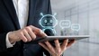 © Rajmina - Businessman interacting with AI chatbot interface on tablet in modern office setting