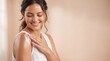 © JAHANGIR - A smiling woman with wavy brown hair wearing a white applying white cream to her shoulder, ad social media download thambnail poster web template event festival 2026 2027 2028