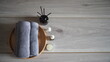 © kanjana - Relaxing spa wellness still life with rolled gray towels, essential oil bottles, aroma diffuser, candle, and wooden tray on a rustic table. Ideal for massage, aromatherapy, beauty, self care, and rela