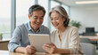 © huaomanz - Happy Senior Couple Consulting Financial Planner in Modern Sunlit Office