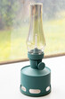 © YouraPechkin - Stylish teal indoor lantern with clear glass shade on windowsill