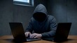 © detiyy - Hacker working on laptop in dark room