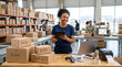 © Mirivox - Smiling woman in warehouse holding tablet with data display, surrounded by boxes, symbolizing logistics, shipping, and business efficiency