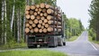 © Generative AI - Heavy logging truck transporting stacked timber logs along rural forest road surrounded by green trees and grass