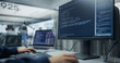 © Gorodenkoff - Unrecognizable Software Developer Typing Program Code and Sql Database Queries on a Desktop Computer Display and Laptop, Building a Cloud Application in an Office With a Diverse Team of Programmers.