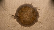 © DreamLens Creations - Dark translucent grease oil stain on brown cardboard pizza box