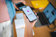 © Studio Marmellata - A person makes a contactless mobile payment by holding their smartphone over another device. This efficient digital transaction takes place in a modern office.