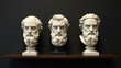 © Jhon - Three marble philosopher busts on dark shelf, wisdom and classical thought concept