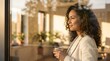 © 5 Grace Media - Smiling African American woman holding coffee cup looking out window.