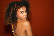 © Gonzalo Infiesta - Beautiful young woman with curly hair looking over shoulder