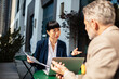 © Davor - Business colleagues discussing project at outdoor cafe