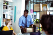 © Davor - Coworkers welcome new employee in modern office