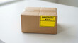 © OPP-786 - Cardboard package with priority label prepared for same day delivery on clean indoor surface