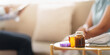 © Natee Meepian - Medication bottles and blood pressure monitor on table during home healthcare visit