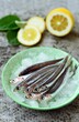 © RooM The Agency - Close-up of a stack of fresh anchovies on ice in a bowl with fresh lemon