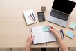© Dmytro Sharapov - Student Organizing Homework Planner at Study Desk