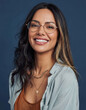 © paultarasenko - Portrait of a smiling woman wearing round glasses on a blue background
