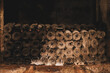 © Mat Hayward - Cobweb and mold covered wine bottles stacked in a Beaune cellar in Burgundy, France, showing decades of quiet aging.