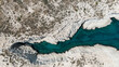 © Mat Hayward - Aerial view of white coastal rocks surrounded by deep blue water near Mandrakia, Milos, Greece, showing the island’s striking geology.