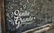 © velikiyzayats - Sonhe Grande written on blackboard with scientific chalk drawings representing motivation education and success