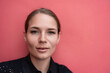 © svetograph - Smiling young woman with clear skin poses indoors against a vibrant pink wall background