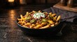 © mytour - Indulgent French Fry Day loaded fries topped with cheddar, caramelized onions, jalapeños, bacon, sour cream, and fresh chives.