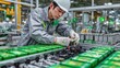 © EUT - Worker precisely assembles green electronic components on factory line. Photo shows modern manufacturing, skilled labor, and technological advancement.