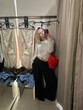 © Asya Molochkova/Stocksy - Fashion Influencer Filming Fitting Room Outfit Review with Smartphone