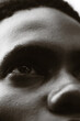 © Nsikanabasi Effiong/Stocksy - Close-up black and white portrait of young Black man's eye.