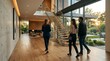 © PixelPulse AI - Real estate agent shows a young couple around a modern luxury home.