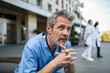 © Davor - Worried male healthcare worker in scrubs outside hospital