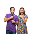 © Kakoli - Surprised couple pointing at each other isolated on white background