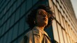 © PixelPulse Creative - Portrait of a stylish woman with curly hair wearing sunglasses and a trench coat against a modern building