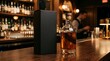 © Fitria - Whiskey bottle with black packaging box on a wooden bar counter in a pub