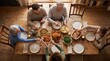 © AV Studio - Family enjoying a traditional roast chicken dinner together at a rustic wooden table, overhead view