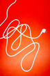 © ADDICTIVE STOCK - White power cord with plug on red background