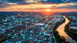 © TrendFrame - Industrial complex at sunset with glowing blue network overlay symbolizing connectivity, smart manufacturing, and iot in supply chain management