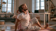 © CreativeArt - Man stretching body on yoga mat in living room, practicing wellness and mindful morning routine at home