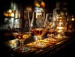 © andi - Whiskey glasses on wooden bar table.