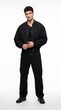 © 3AN - Full length portrait of handsome male model wearing black bomber jacket, black tank top, and black cargo pants isolated on white background.