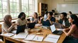 © Usman - Diverse students collaborating around a wooden table with laptops in a bright modern classroom, smiling and engaged in active group study