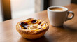 © ramdani - A Moment of Delight: A delectable Portuguese custard tart rests beside a steaming cup of coffee, offering a perfect indulgence for a morning treat or an afternoon pick-me-up.