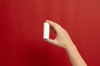 © Antonio - Hand holding blank white cosmetic roll-on bottle