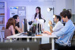 © Wosunan - A diverse business team listens to a project manager presenting a project in a modern office meeting