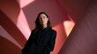 © BlackBridge Media - Stylish Confident Woman Posing in Modern Pink Architectural Setting