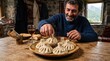 © primipil - Man eating traditional georgian khinkali dumplings in rustic mountain house with wine. Concept of georgian food, georgia, rustic meal.