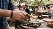 © MDBadrul - A man peeling charred grilled spring onions at an outdoor social gathering