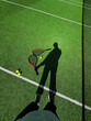 © Asya Molochkova/Stocksy - Shadow of a tennis player with rackets